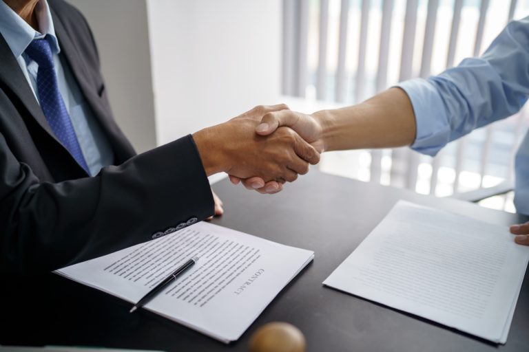 Lawyer Legal counsel Businessman shaking hands successful making a deal.